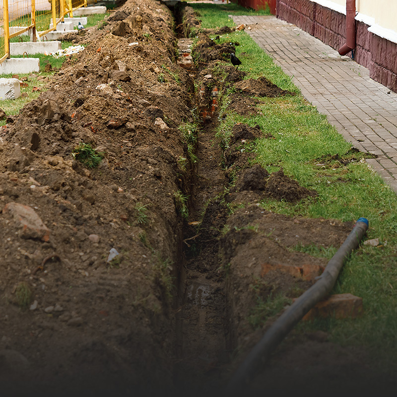 Drainage system trench with a visible hose and pipe installed in Louisville, KY